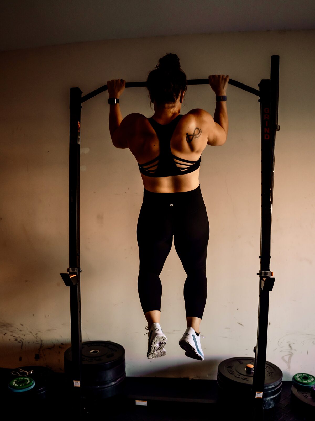 Allie Jackson doing a pull-up in her home gym